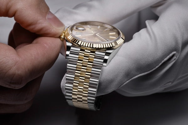 Rolex technician performing final quality control check during servicing
