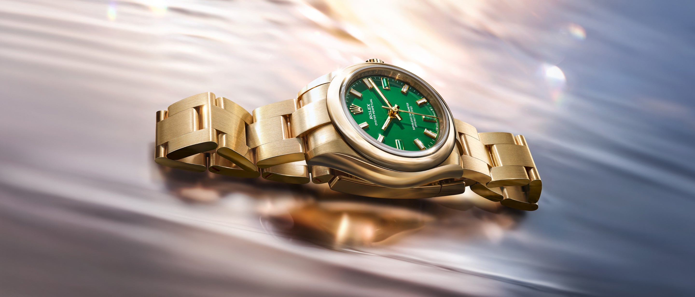 Rolex Oyster Perpetual 28 in yellow gold and Oyster Perpetual 34 in Everose gold with natural stone hour markers at 3, 6 and 9 o'clock